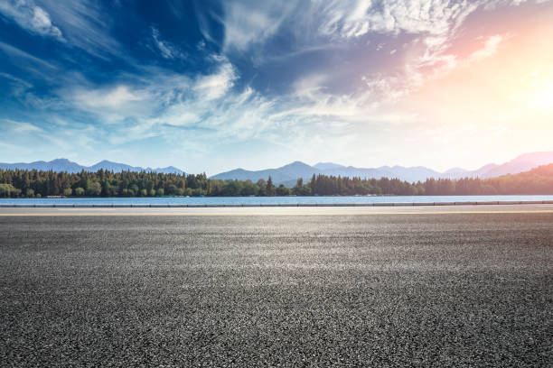 Asphalt road and hills with sky clouds landscape at sunset